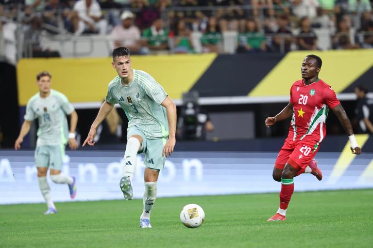 C&eacute;sar Montes competes with Gleofilo Vlijter during a 2025 Gold Cup group stage match