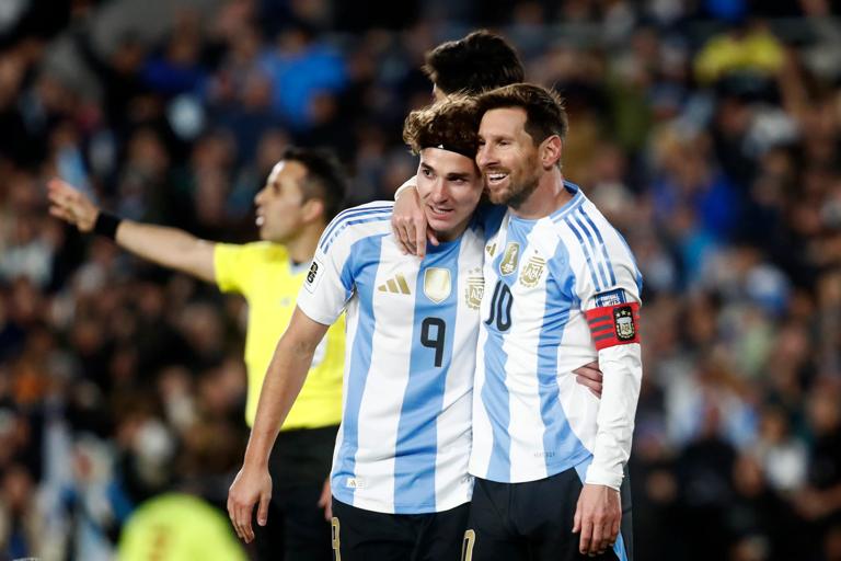 BUENOS AIRES, ARGENTINA - SEPTEMBER 04: Lionel Messi of Argentina celebrates with teammate Julian Alvarez after scoring the team's first goal during the South American FIFA World Cup 2026 Qualifier match between Argentina and Venezuela at Estadio M&Atilde;&iexcl;s Monumental Antonio Vespucio Liberti on September 04, 2025 in Buenos Aires, Argentina. (Photo by Marcos Brindicci/Getty Images)